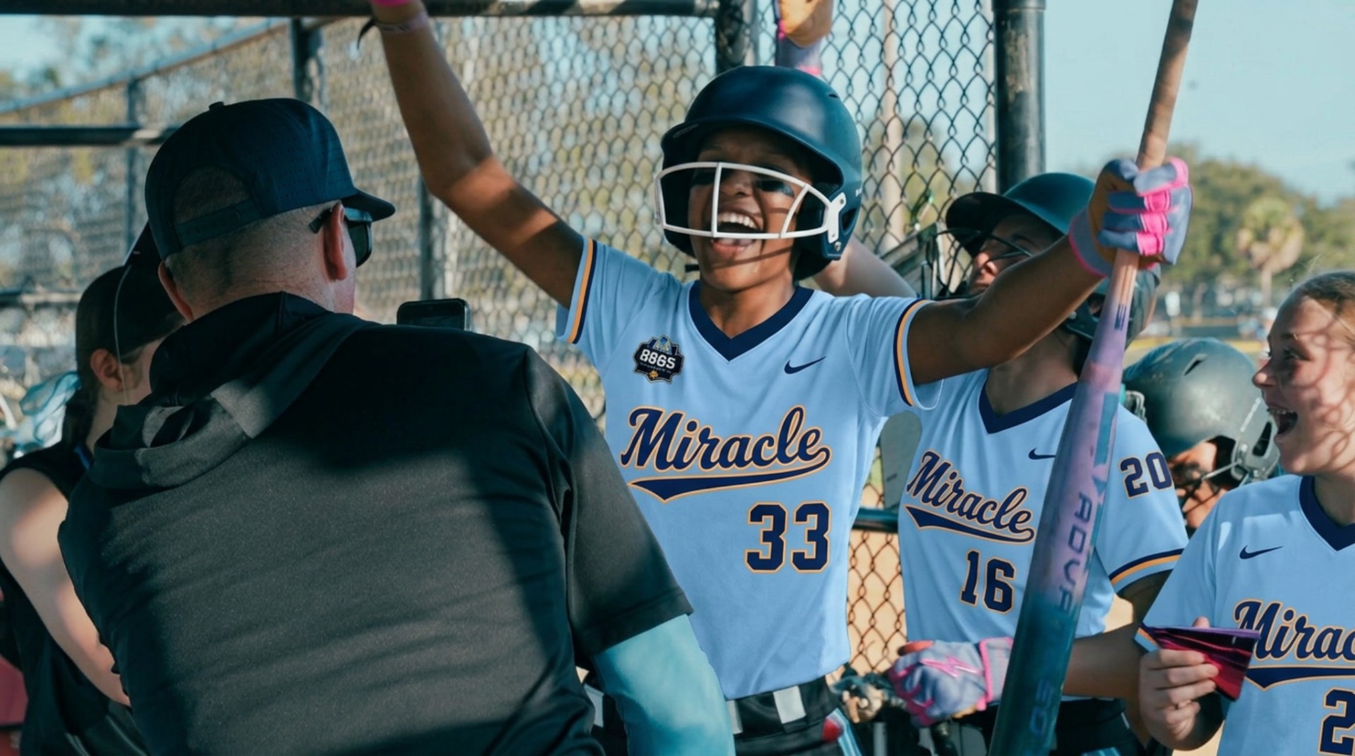 Young Junior Miracle player celebrating in the dugout